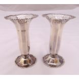 A pair of Victorian hallmarked silver pierced and panelled vases on spreading bases, London 1900,