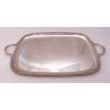 A hallmarked silver presentation tea tray, rounded rectangular with husk border and two leaf mounted