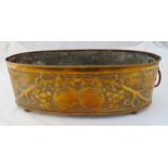 An Arts and Crafts copper embossed jardinière of oval form, chased with fruits and leaves and with