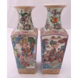 A pair of Chinese tapering rectangular vases decorated with figures in stylised landscapes, 36cm (