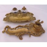 A brass desk set of Rococo form to include a pen stand and two detachable glass inkwells (2)