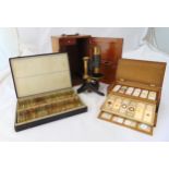 A cased brass mounted microscope and two wooden fitted boxes of pre made slides
