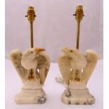A pair of carved marble table lamps in the form of eagles on raised rectangular plinths, 38.5cm (