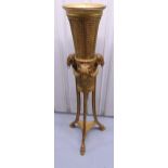 A gilded wooden and rattan plant stand of tapering cylindrical form with Ram mask and hoof