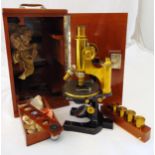 Zeiss brass microscope with a selection of lenses in fitted mahogany case with carrying handle, 38cm