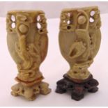 A pair of oriental soapstone vases pierced and carved with stylised dragons, 32cm (h)