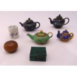 Four miniature cloisonné teapots, a malachite box and cover, a ceramic covered box and a metal