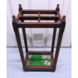 A mahogany rectangular umbrella and stick stand with detachable lead base, 69 x 35.5 x 25.5cm
