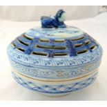 A Chinese blue and white ceramic censor, the pierced pull off cover with lion finial, 16cm (dia)