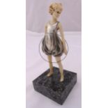 An Art Deco style silver plate and composition figurine of a young girl holding a hula hoop on