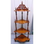 A Victorian mahogany four tier whatnot, scroll pierced and turned baluster supports, 138 x 60cm