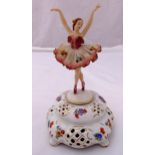 Thorens porcelain musical revolving ballerina on raised shaped oval base, details to the base,