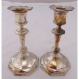 A pair of hallmarked silver table candlesticks, Georgian style on raised octagonal bases, Birmingham