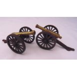 A pair of match strikers in the form of brass and metal miniature cannons, 21cm (l)