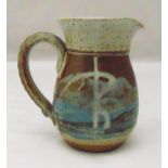 A Studio ceramic pottery jug with seal mark to handle and incised mark to base, brown and blue