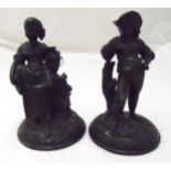 A pair of bronzed figurines of a boy and girl in 18th century attire on raised circular bases, 17.