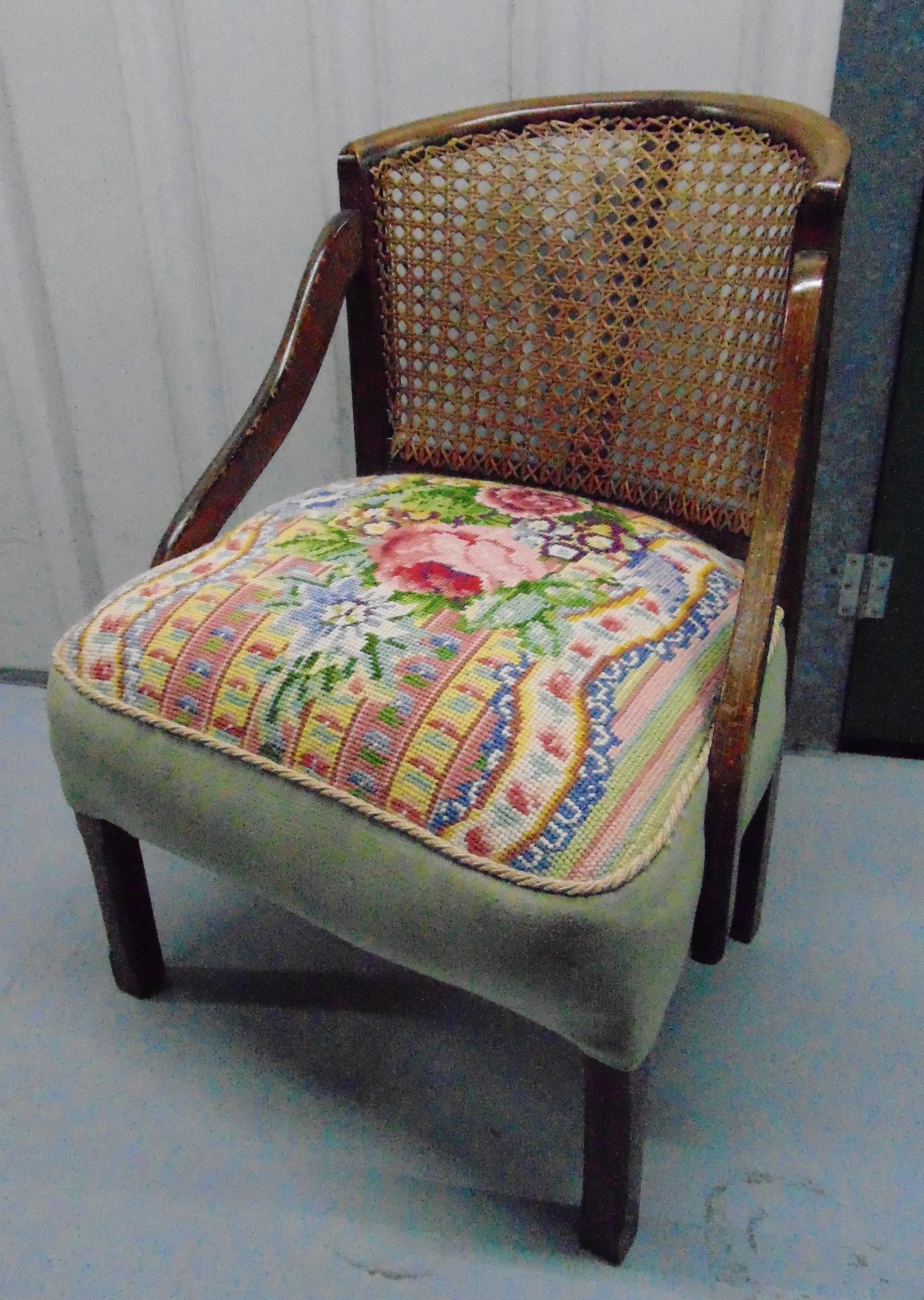 An early 20th century tub chair with tapestry seat and caned back