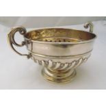 A hallmarked silver two handled rose bowl, part spirally fluted with pierced double scroll handles