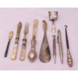 Two silver propelling pencils, a silver and mother of pearl caddy spoon, a knife, a fork, a letter