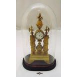 A French 19th century gilt metal mantle clock of drum form, white enamel dial flanked by two