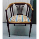 An Edwardian mahogany occasional chair with upholstered seat on four tapering cylindrical legs