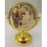 A polychromatic stonework globe in calibrated brass mounts on raised circular base, 35cm (h)