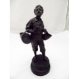 Eutrope Bouret bronze figurine of a boy holding baskets on raised circular base thought to be a