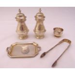 A quantity of hallmarked silver to include condiments, a pair of sugar tongs, a coaster and a