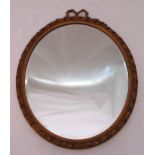An oval framed bevelled edge wall mirror, 61 x 44.5cm