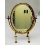 A brass mounted oval dressing table mirror on four scroll supports, 46.5cm (h)