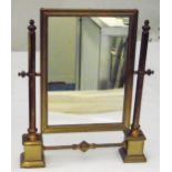 A brass mounted rectangular dressing table mirror with cylindrical supports on square plinths, 41.