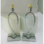 A pair of chrome table lamps of looped form on rectangular bases with shades, 36cm (h)