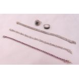 Three silver bracelets set with diamonds and rubies and two silver and diamond rings