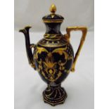 A continental porcelain teapot decorated with gilded scrolls and simulated bamboo handle on raised