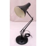 Anglepoise black enamel desk lamp of customary form on raised circular base, A/F