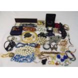 A quantity of costume jewellery to include earrings, rings, necklaces, brooches and bangles