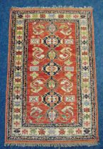 A Middle Eastern wool carpet with central repeating pattern and border, 164 x 103cm