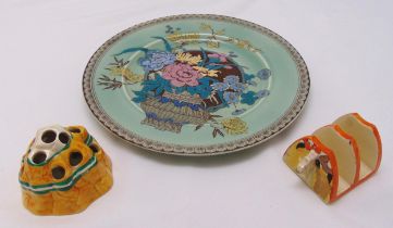 A Clarice Cliff Bizarre toast rack, a Clarice Cliff flower frog and a Clarice Cliff Ophella plate