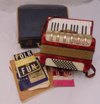 A Hohner Student accordion in fitted case to include accompanying sheet music