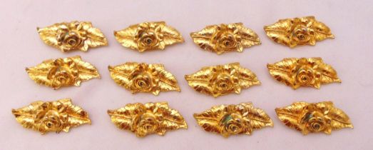 Twelve gold plated place card holders in the form of a rose on a leaf