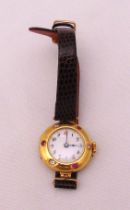 18ct yellow gold ladies wristwatch set with diamonds and rubies on a replacement leather strap