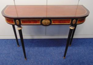 A Regency style shaped rectangular consol table on four tapering cylindrical legs with applied