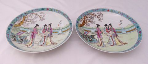 A pair of 20th century Cantonese style dishes decorated with figures in a landscape,