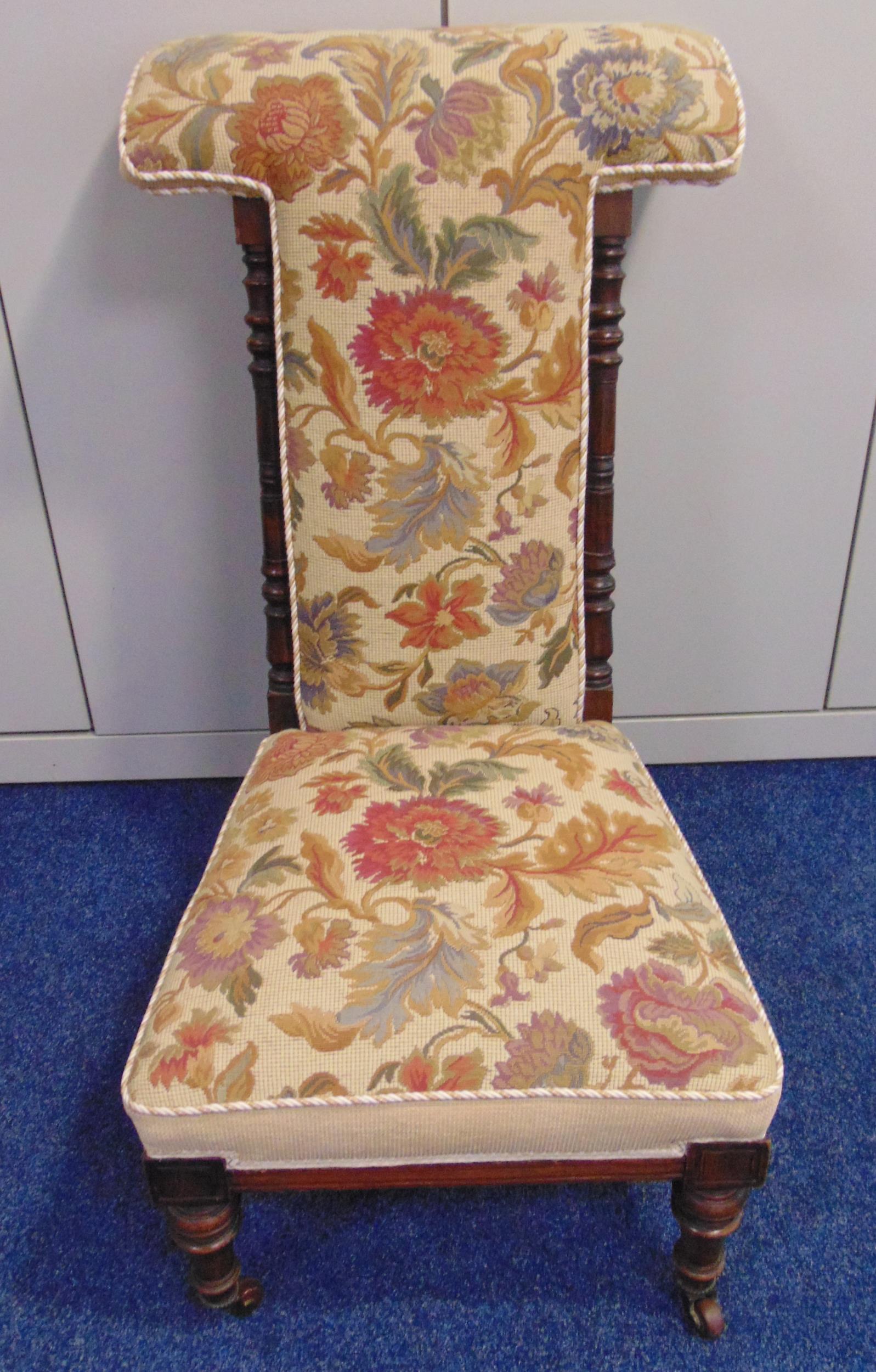 An upholstered mahogany prayer chair of customary form on turned supports