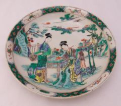 A Chinese famille verte porcelain dish decorated with stylised figures in a landscape, 28.5cm (dia)