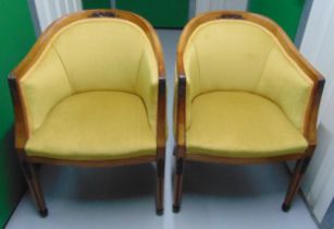 A pair of upholstered continental Art Deco tub chairs on tapering rectangular legs