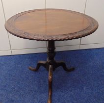 A Victorian mahogany tilt top circular occasional table with carved wooden outswept legs, 67 x 73.