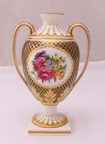 A Spode Regency vase with side handles decorated with flowers and gilding on square base, marks to