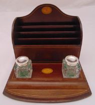 An Edwardian mahogany and satinwood shaped rectangular desk stand to include two glass inkwells with