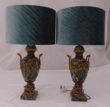 A pair of onyx and gilt metal table lamps, ovoid form on raised square plinths, with silk shades,